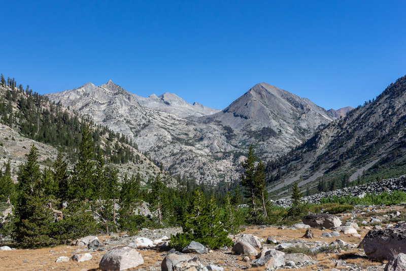 Looking back down the valley on the John Muir Trail with Pyramid Peak, Window Peak, and Castle Domes in the far.