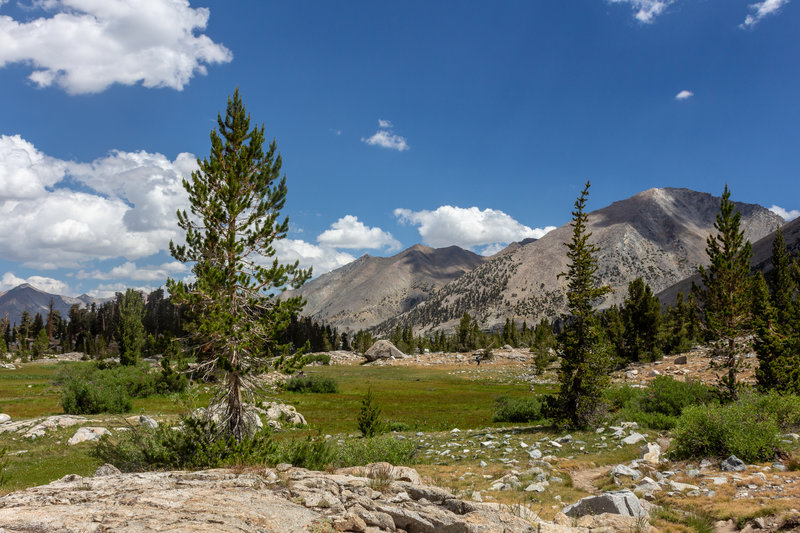 Arrowhead Lake is surrounded by green meadows.