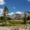 Arrowhead Lake is surrounded by green meadows.