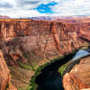 The canyon is bigger than I imagined. For scale, you can see a person sitting on the ledge on the left side.