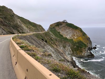Even beneath overcast skies, appreciating the sharp contrast between rock and sea demands more time than cars will ever provide.