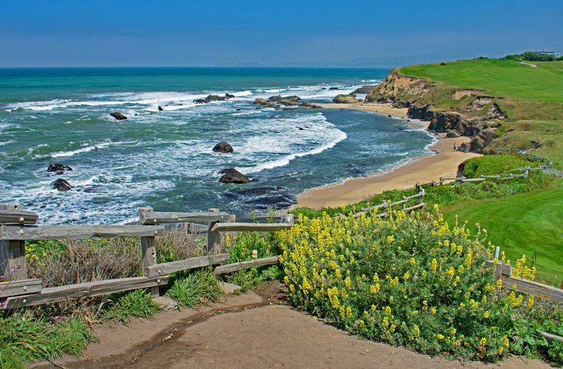 Beach, rocks, and golf course from trail on north side of the Ritz Carlton Hotel.