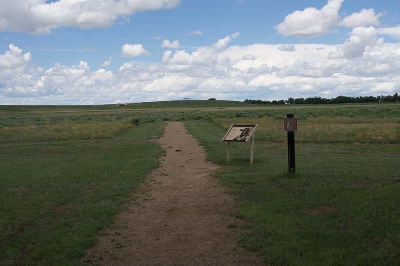 The trail departs the picnic area and heads toward the monument on the hill, roughly 0.5 miles away.