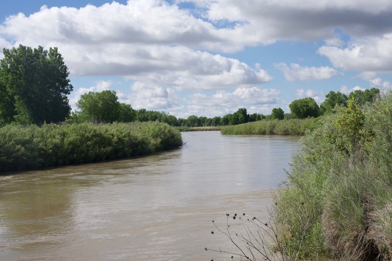 The Arkansas River runs next to the fort. After an evening of thundershowers, the river runs higher than normal.