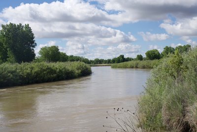 The Arkansas River runs next to the fort. After an evening of thundershowers, the river runs higher than normal.