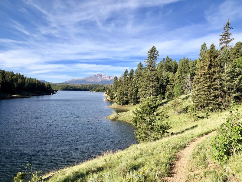 Trail bends around the reservoir and you can see Pikes Peak and Almagre in the distance.