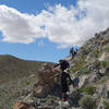 Hikers descending into Smoke Tree Canyon on a tricky stretch of trail