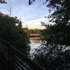 View of walking bridge toward wooden vehicle bridge.