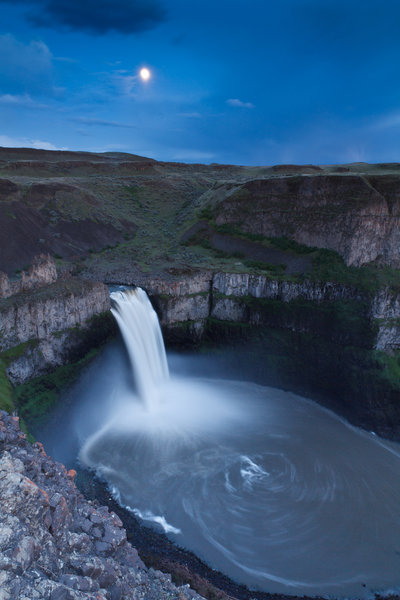 Palouse Falls at night under a bright moon.