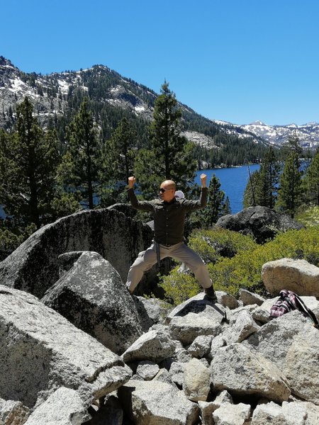 Massive rocks by the Echo Lake Trail, with the lake and mountains in the background. (June 2019)