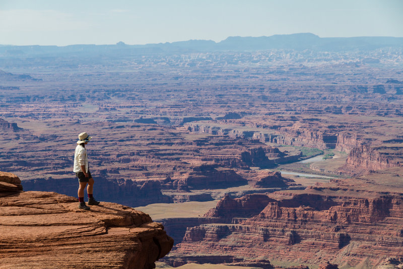 The view down to the Colorado River from Dead Horse Point (wife for scale).