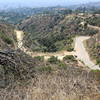 High road or low road. Coming off the dirt trail to the left, you head to the front of the sign; to the right, you head to the back of the sign. Both are paved roads to the destinations.