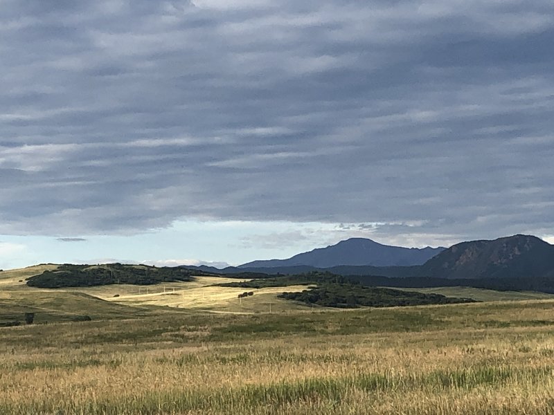 Pikes Peak looming behind the buttes.