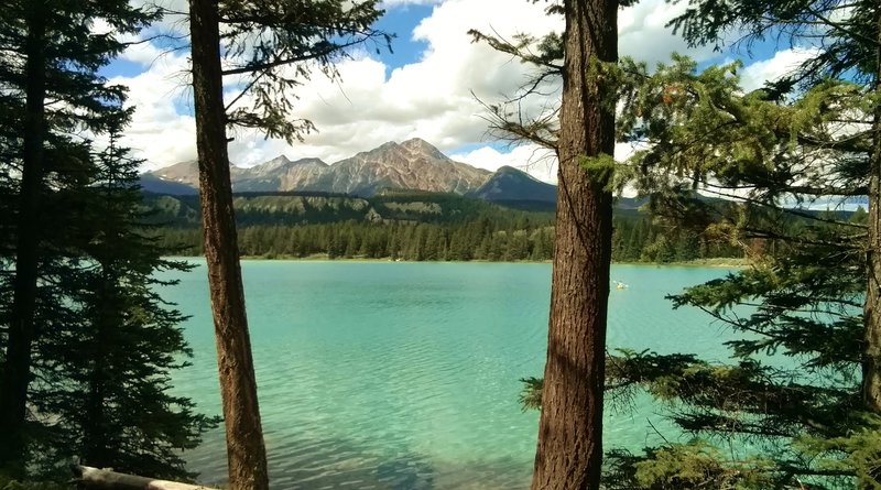 The turquoise waters of Lake Annette with Pyramid Mountain in the distance (center).