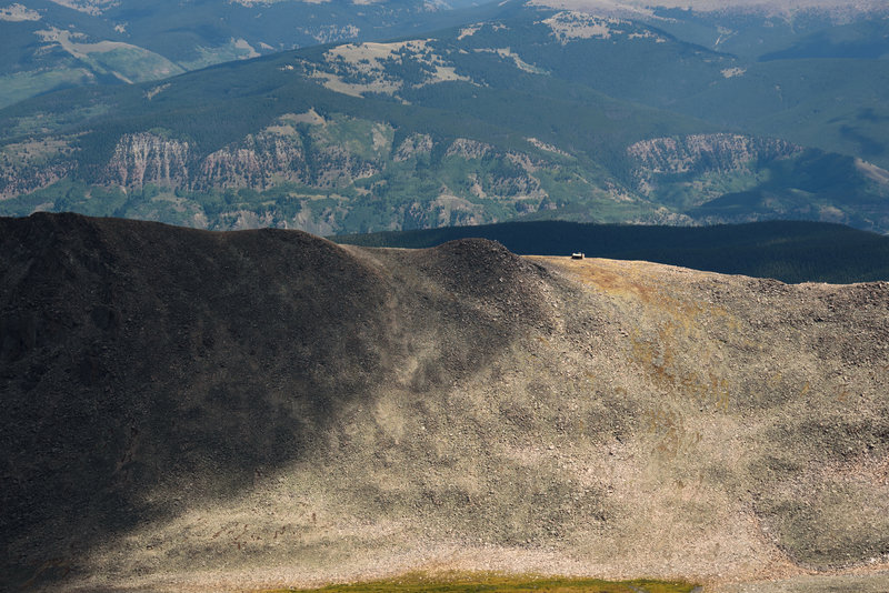 Tiny hut on a ridge below the summit