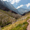 Matahpi Peak slowly emerging on the left on the ascent to Siyeh Pass