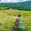 A young hiker enjoys the view of Whigg Meadow and beyond.