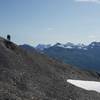 The trail narrows and wraps around the hillside and offers sweeping views of the mountains of the Kenai Peninsula.