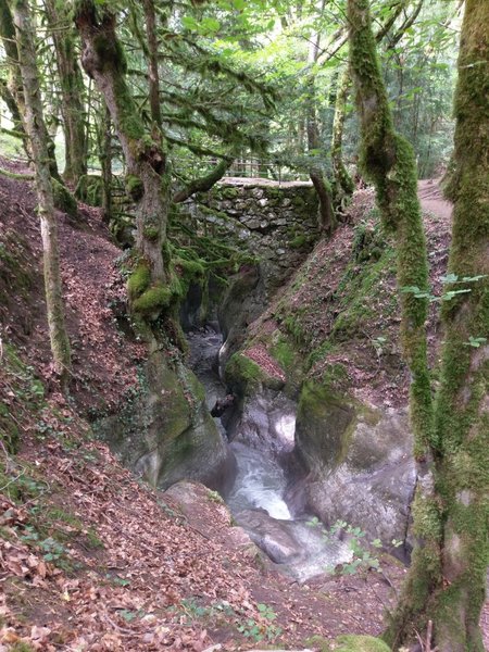 Stone bridge over swirling water (Pont des Fees)