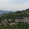 Viewpoint over the lake, canyon, and obliging paragliders