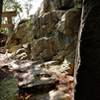 Neat "gap" through boulders exiting onto a bridge with a great view.