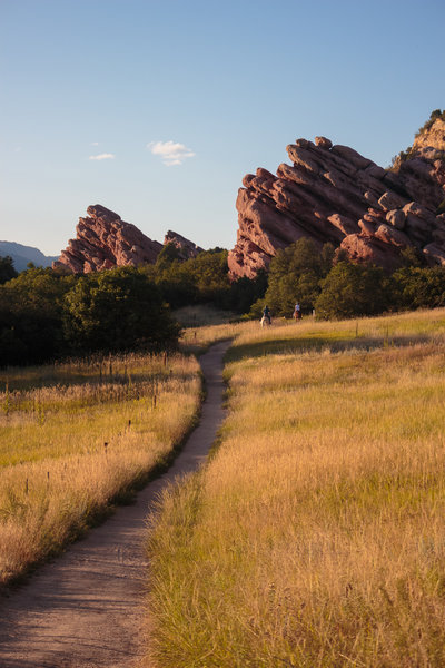 Horse riders and rock formations during golden hour