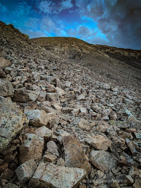 Out of the weeds now, about halfway to the summit. Mostly rock and boulders trail from here on up. Follow the cairns.