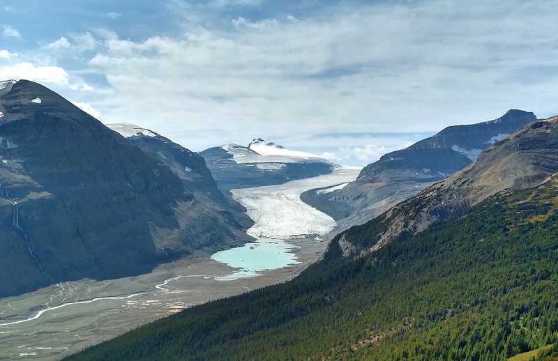 Castleguard Mountain in the distance (center) rises above Saskatchewan Glacier. Melt water from the glacier is the beginning of the North Saskatchewan River.