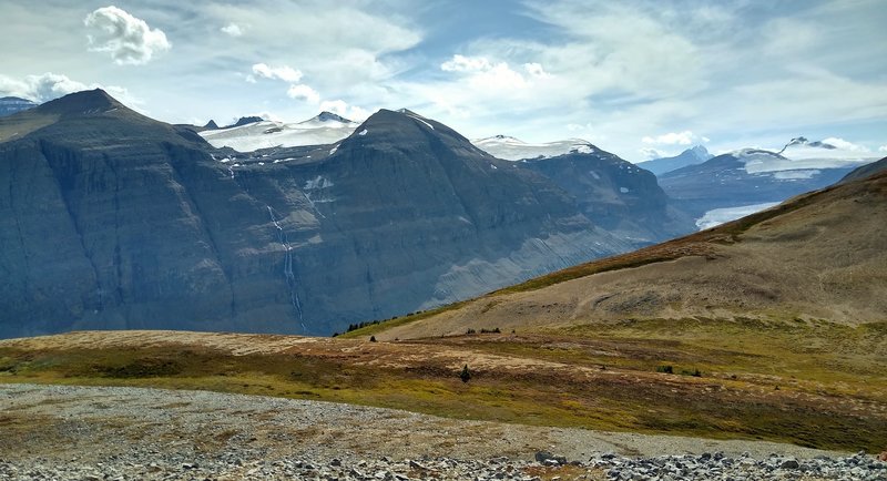 Hidden, the Saskatchewan Glacier and North Saskatchewan River run down the deep valley. Mount Saskatchewn peeks out in the distance on the far left. Castleguard Mountain is in the distance on the far right. Seen looking southwest from Parker Ridge Spur.