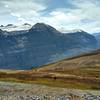 Hidden, the Saskatchewan Glacier and North Saskatchewan River run down the deep valley. Mount Saskatchewn peeks out in the distance on the far left. Castleguard Mountain is in the distance on the far right. Seen looking southwest from Parker Ridge Spur.