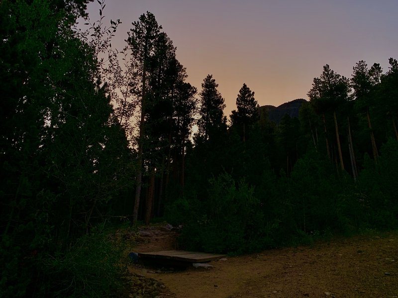 At the top of the Trailhead road, this small footbridge begins the trail up.