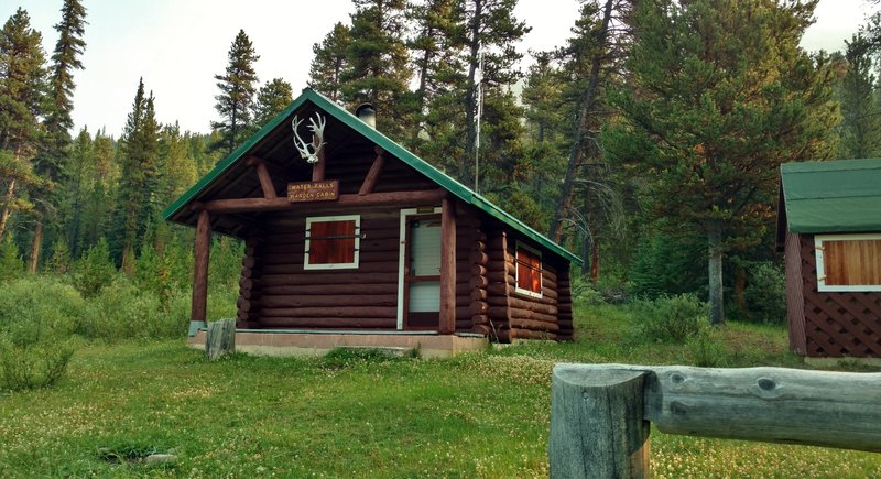 Waterfalls Warden Cabin. About a century old, this very well preserved warden cabin and out buildings is found along Pobokatan Pass Trail. Overlooking Poboktan Creek, it has a great view of Waterfalls Peak from its front porch.