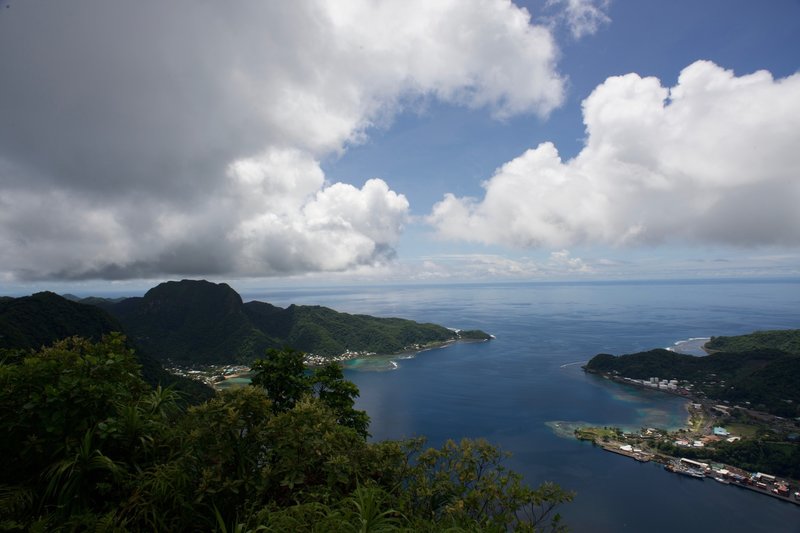 Pago Pago Harbor sits below the summit of Mount Alava.  You can see where the coral reefs are in the bay below.