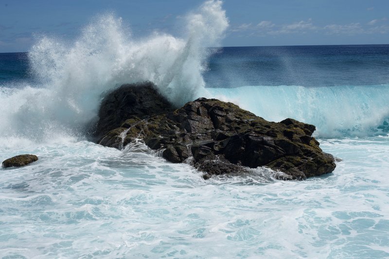 Waves crash into the shoreline on the beach at the end of the Pola Island Trail.