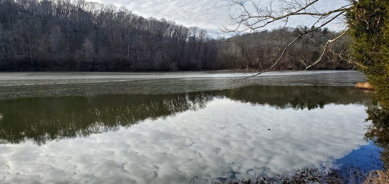 A thin film of ice covers most of the lake on a December morning