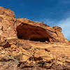 A large alcove forming just above the Syncline Loop Trail