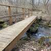 Bridge over stream near Wiesel Youth Hostel. Closed trail path in background.