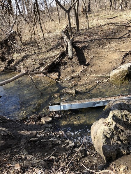 The bridge is washed out.  You can get across here, but there is also a go-around trail that takes you up to the road to get across this creek.