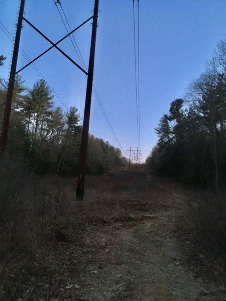 Looking up to where trail crosses Bay Road, and where this is room for 2 cars to park.