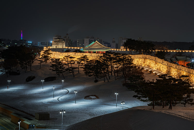 The Fortress wall lit up at night