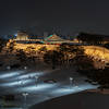 The Fortress wall lit up at night