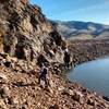 Scrambling below the cliff to the dam beyond (low water route)