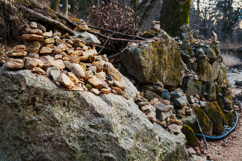 Lots of stacked rocks by the temple stream