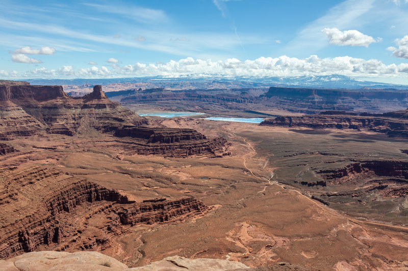 Shafer Basin evaporation ponds and snow covered La Sal Mountains from Dead Horse Point Overlook