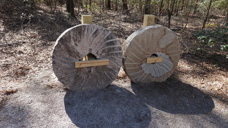 Retired millstones on the trail