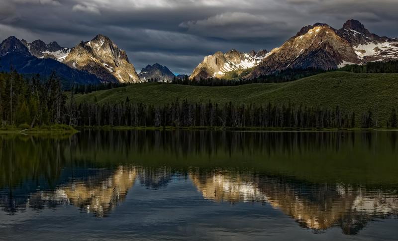 While out early exploring the Sawtooth Mountains near Stanley, Idaho I came across this scene where the first rays of morning light accentuating the mountain peaks.