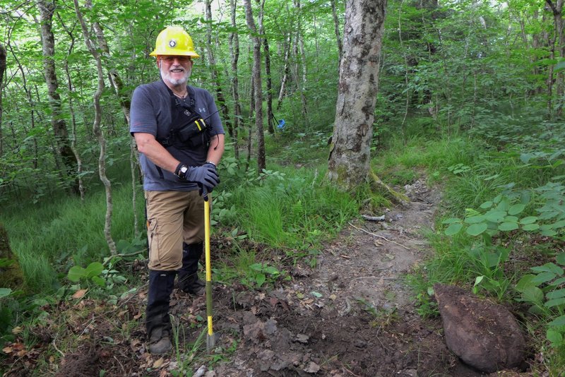 Volunteer trail maintainer builds steps on the trail leading to Bob Bald