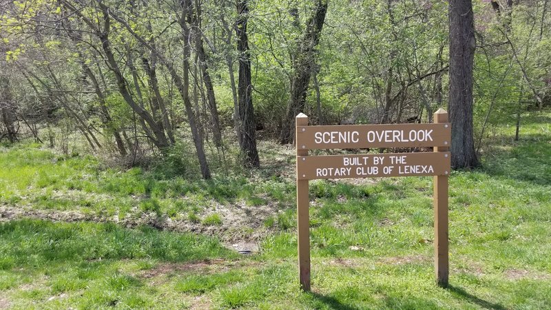 The sign is obvious, but it might not be clear to some that this is the trailhead.  Just start walking through the opening in the trees and the trail will start to become more visible.