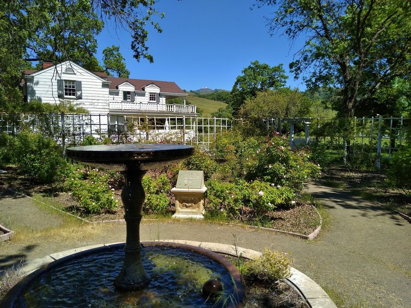 The historic Ranch House, set in the Diablo Range hills, as seen from the Rose Garden.  Mt. Hamilton, 4,265 ft. is in the distance, upper center.