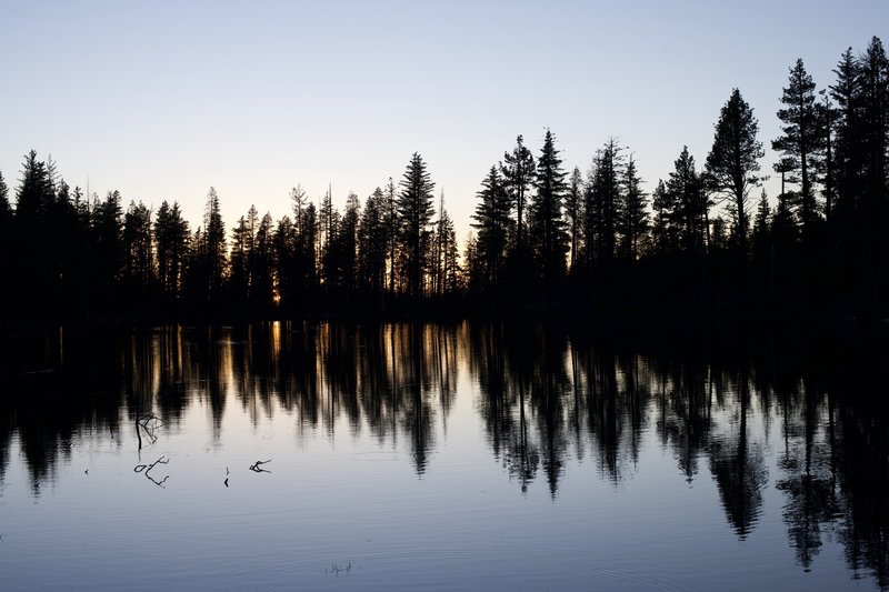 While Lassen Peak is definitely the main attraction at sunset, the view to the west is also pretty magical, as the western sky lights up through the trees the line the lake.